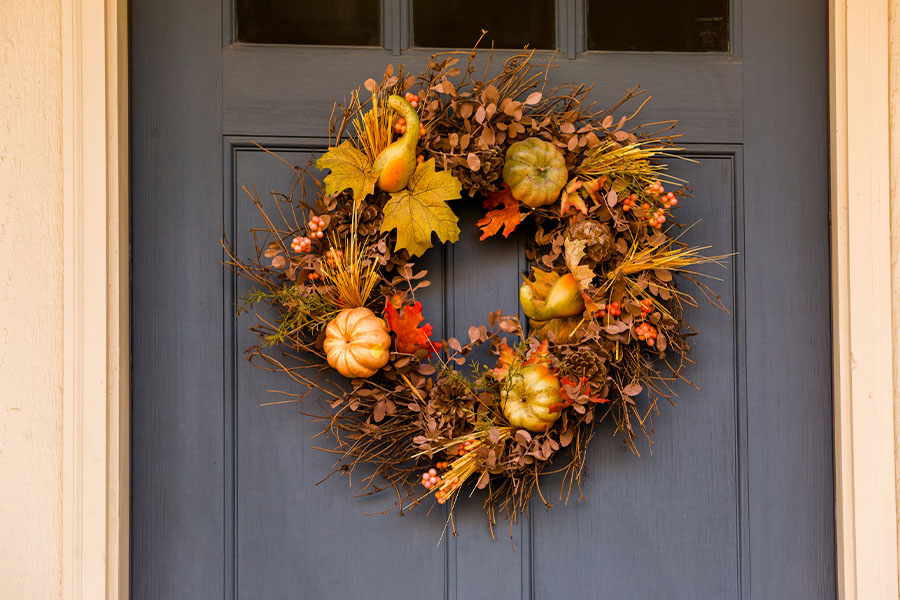 Fall wreath on a navy blue door close up.