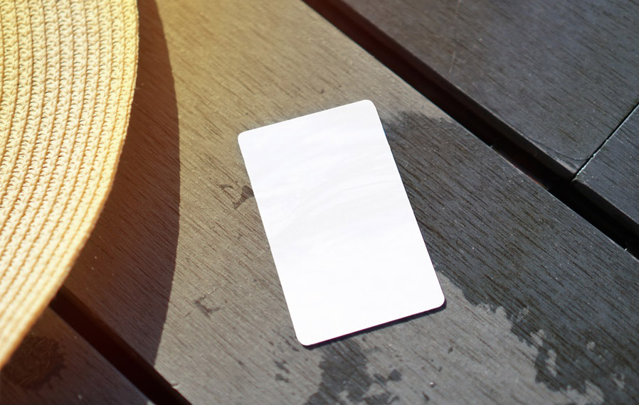 Don't forget your pool pass to to take a refreshing swim at Union Street Flats. Summer hat and key card on a deck floor.