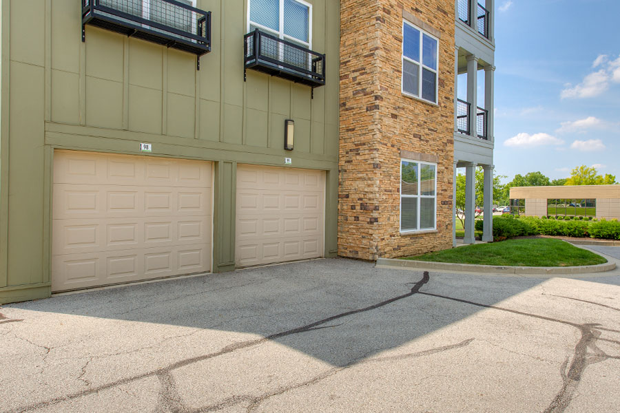 Attached parking garage at One One Six Apartments. Exterior view of the garages tucked underneath the upper level apartments.