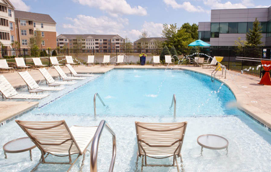 A beautiful blue pool enhances your apartment experience in Westfield. Lake side pool on a sunny day.
