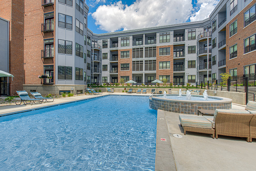Swimming pool with deck seating at apartment community