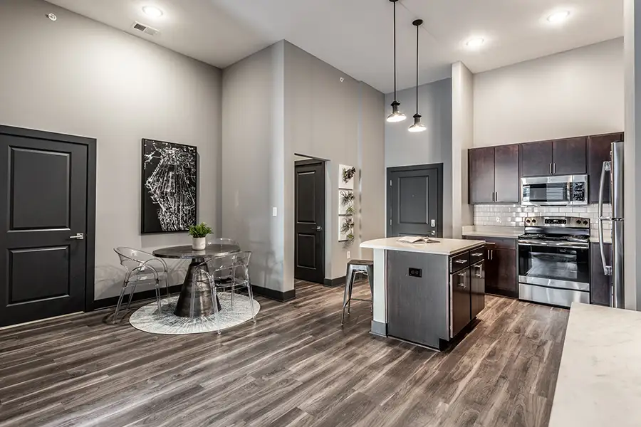 A contemporary apartment kitchen, dining room, and entryway